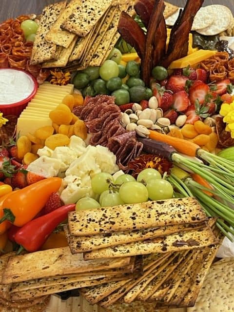 meats, cheese, fruit in a box