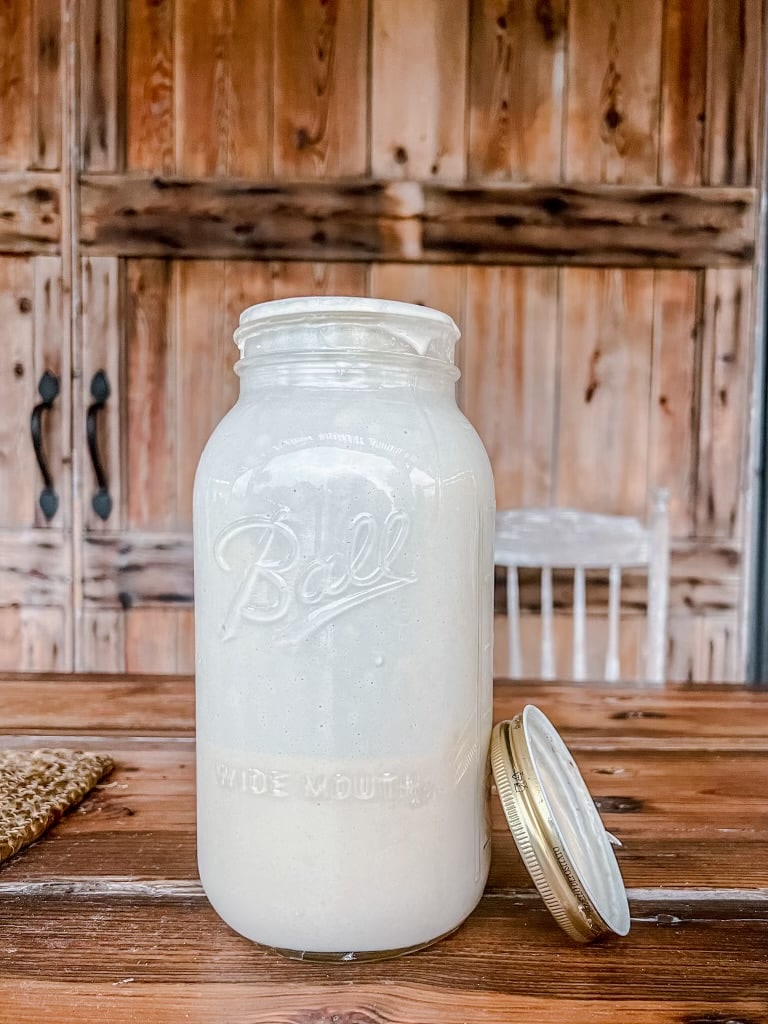 Ball canning jar with sourdough starter inside.