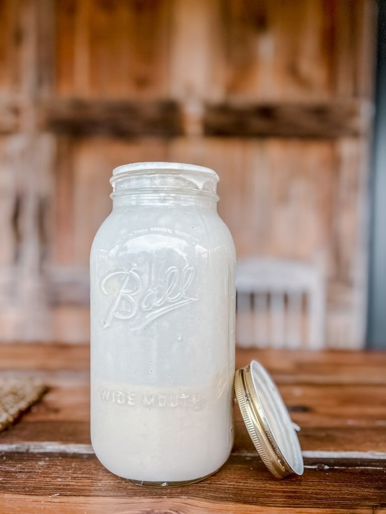 Ball canning jar with sourdough starter inside.